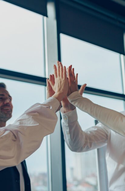 Group of businesspeople stacked hands after finishing project in office. High quality photo